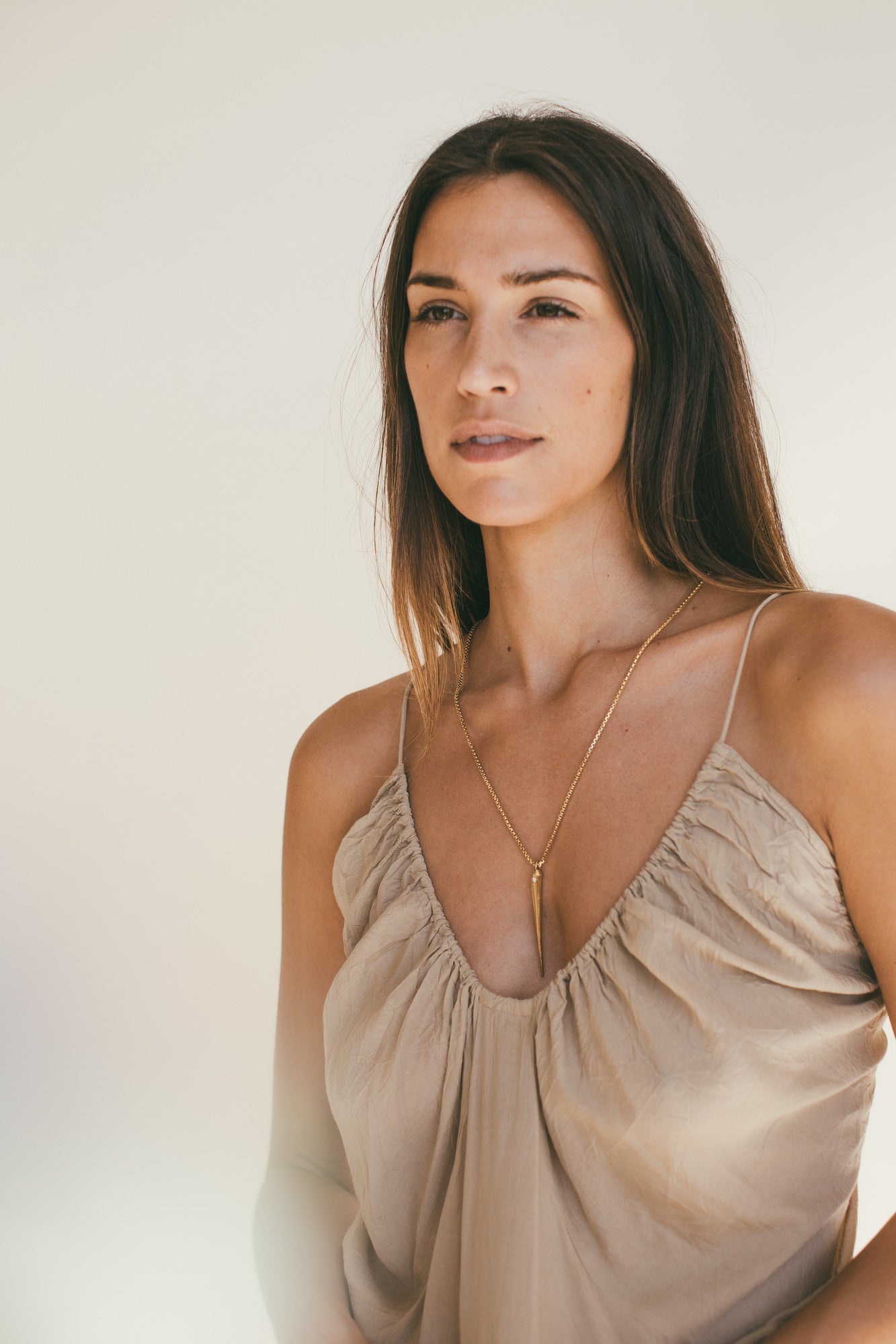 A MODEL WEARING THE GOLD SEA URCHIN SPIKE CHARM WITH DIAMOND
