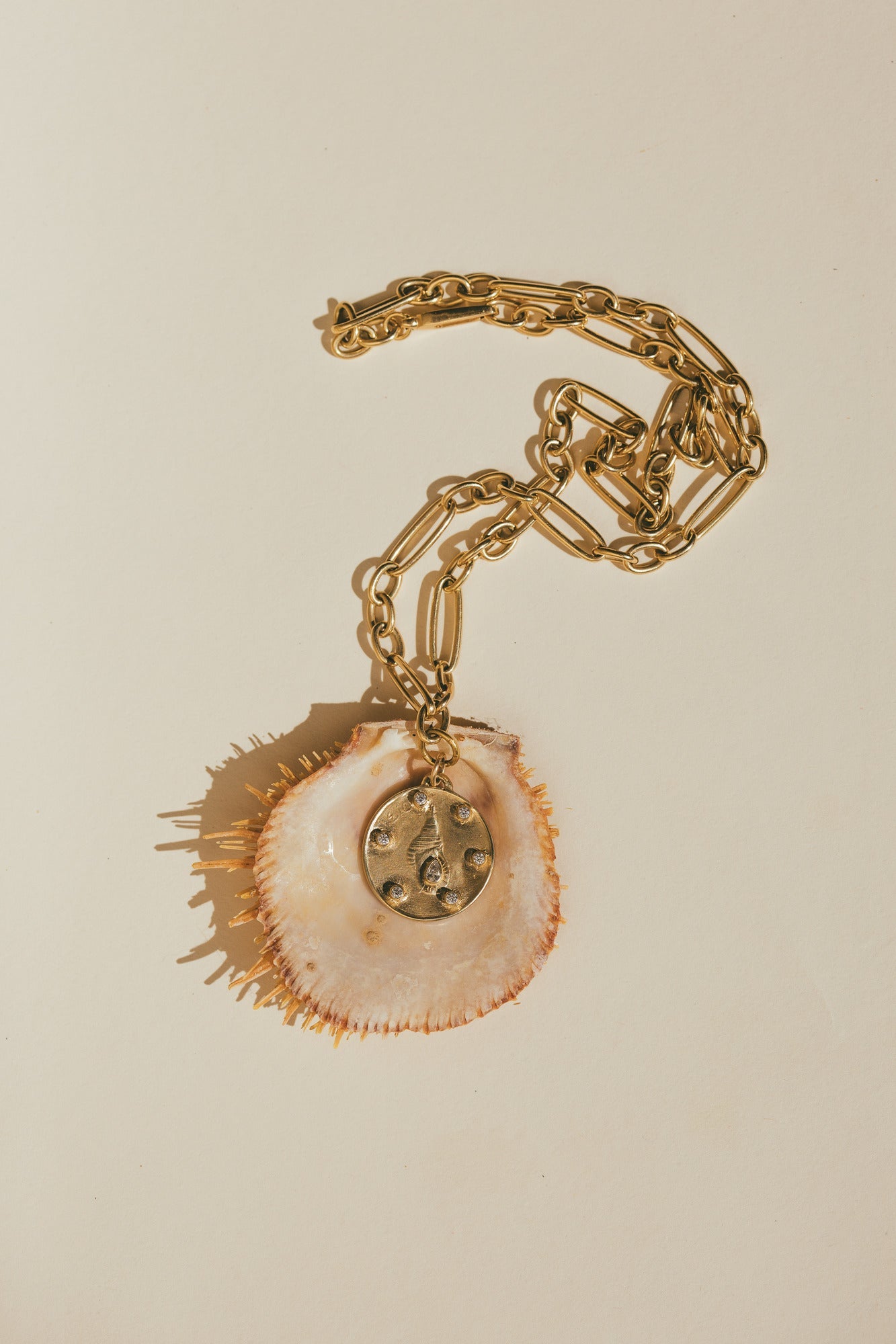 THE LARGE GOLD HORN SHELL CHARM WITH DIAMONDS ON A SPIKEY SEA SHELL