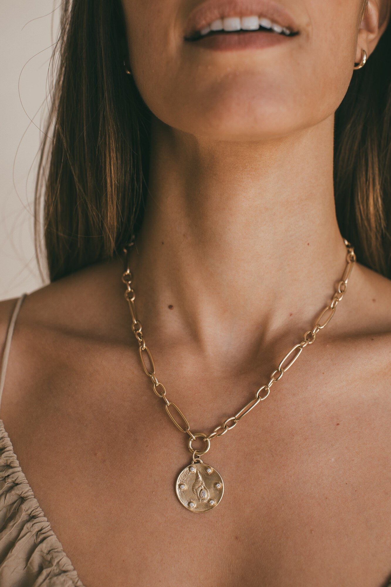 LARGE GOLD HORN SHELL CHARM WITH DIAMONDS AROUND THE MODELS NECK