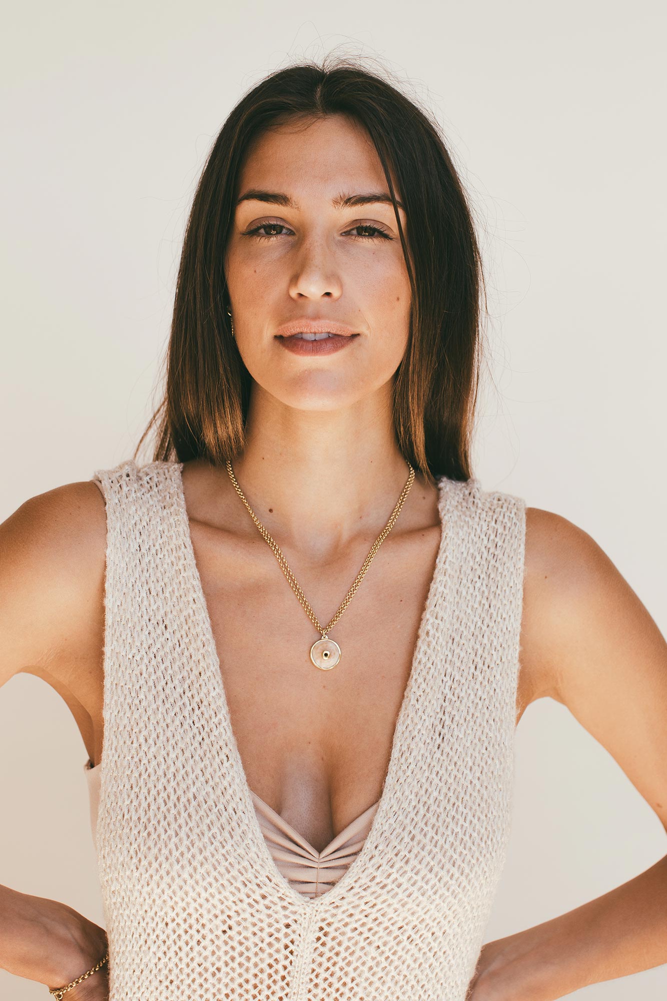 Model from the front wearing puka rivet charm.