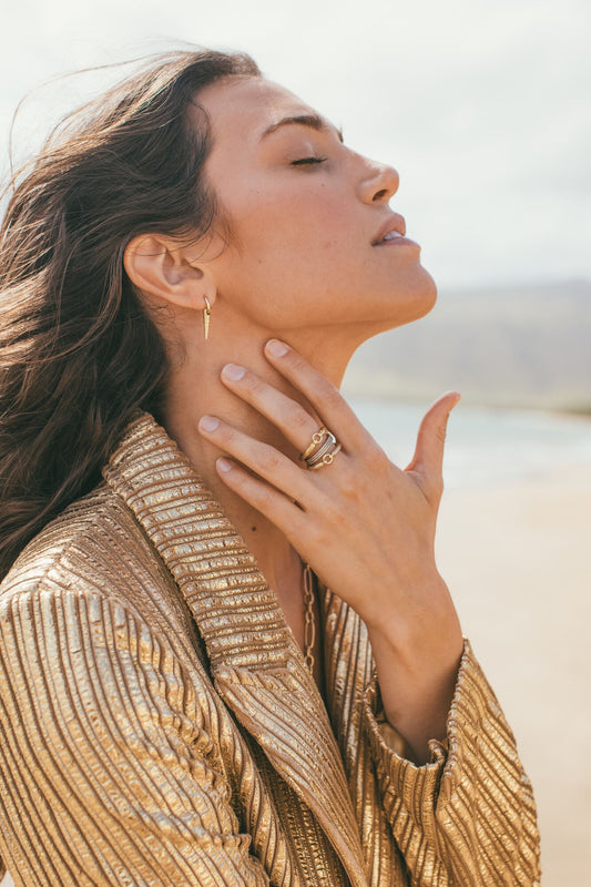 A MODEL WEARING THE 14KT & 18KT POKER SHELL EARRINGS ON HER RIGHT EAR