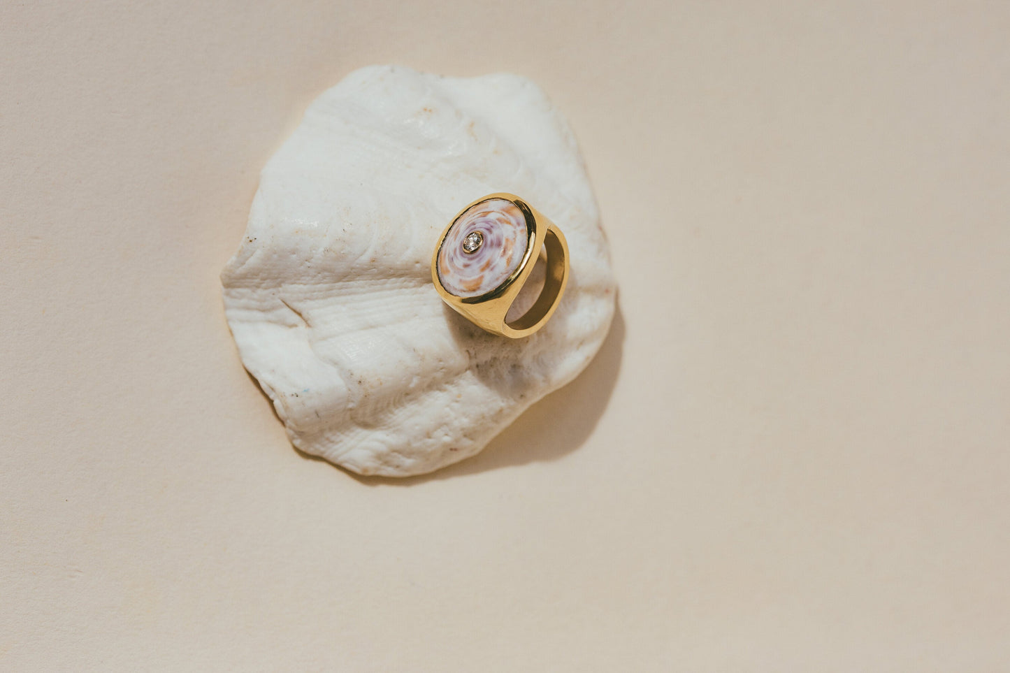 A CLOSE UP OF THE 18K GOLD PUKA RING WITH DIAMOND-ONE-OF-A-KIND