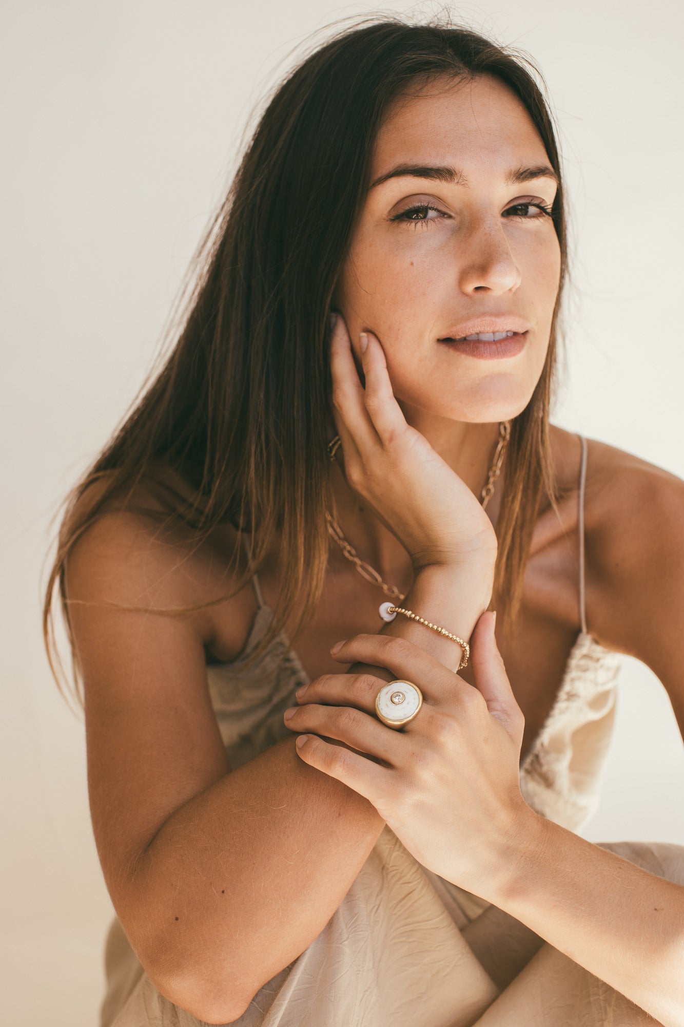 A MODEL FACING THE CAMERA WEARING THE 18K GOLD PUKA RING WITH DIAMOND-ONE-OF-A-KIND-WHITE