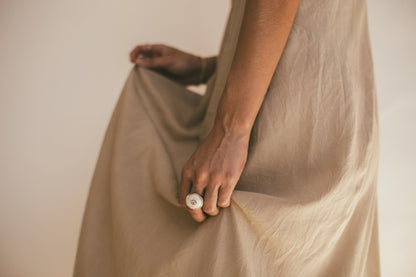 A MODELS LEFT HAND WEARING THE 18K GOLD PUKA RING WITH DIAMOND-ONE-OF-A-KIND-WHITE 