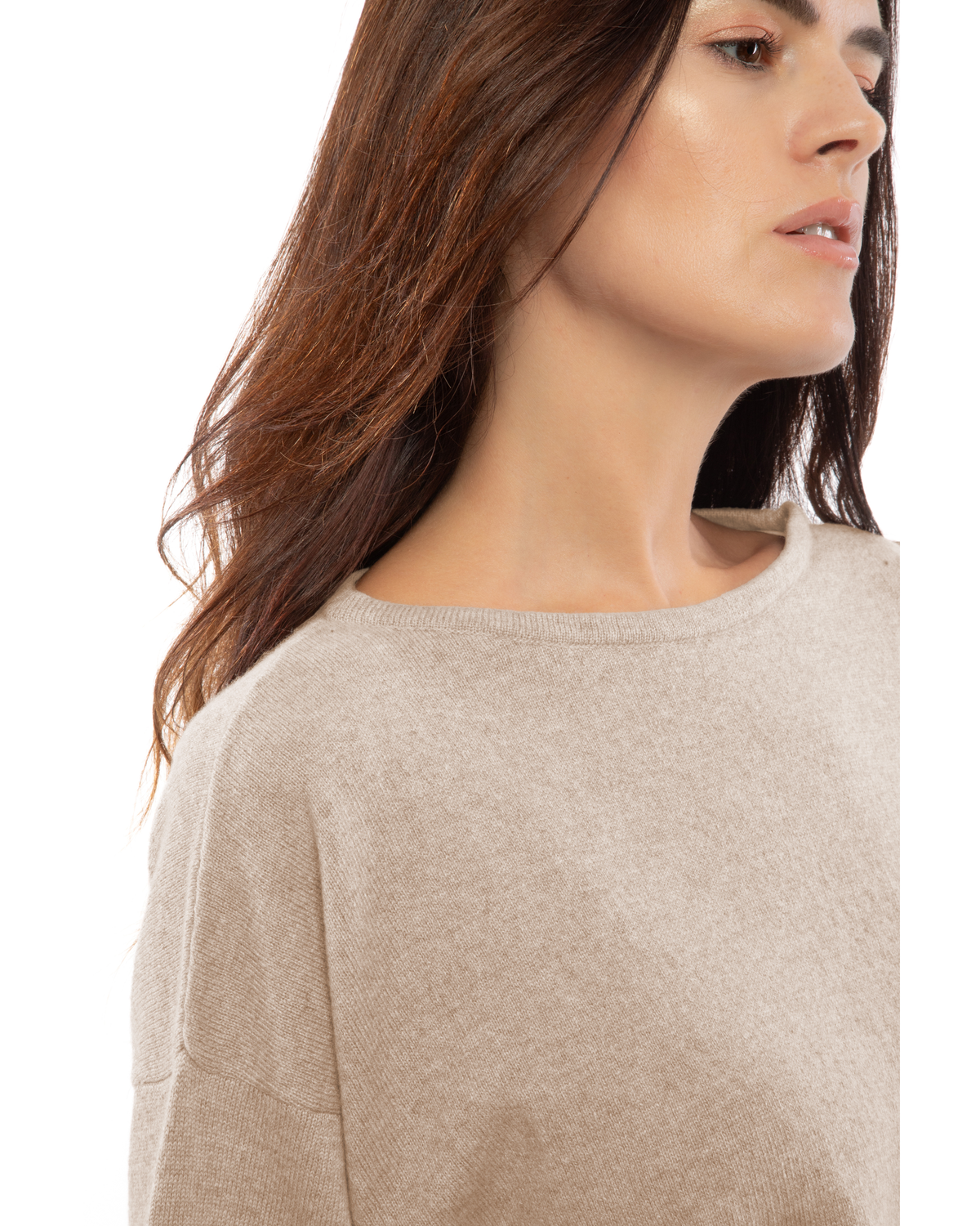 Close-up of beige cashmere boatneck sweater, showing boat neckline and shoulder.