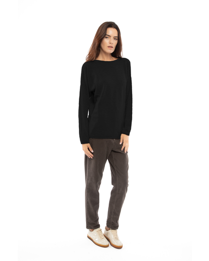 Model wearing the black relaxed cashmere boatneck sweater