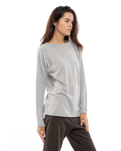Model wearing a cashmere relaxed maxi boatneck sweater in light gray, front view