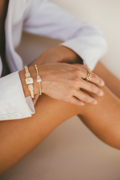 A CLOSE UP IMAGE OF A MODEL WEARING THE GOLD HANSEN RING 