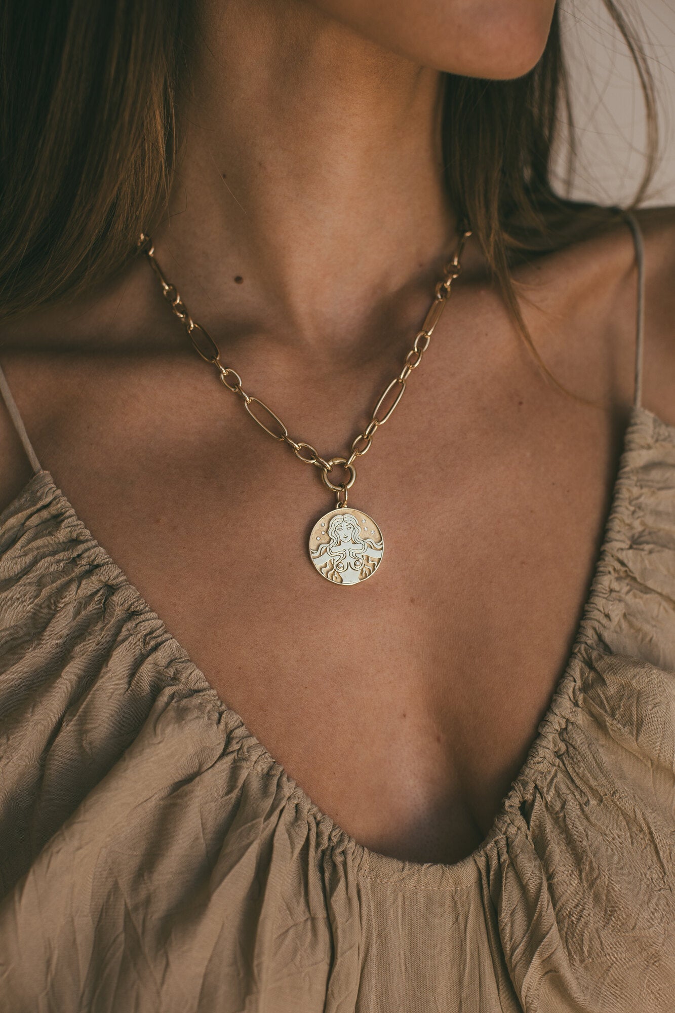 A MODEL WEARING THE GOLD MERMAID DIAMOND CHARM AROUND HER NECK 