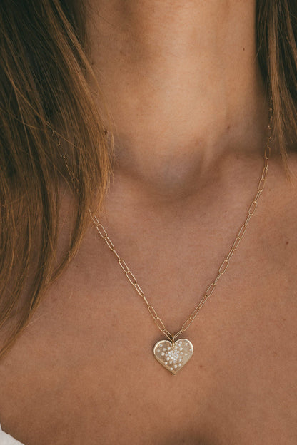 A CLOSE UP OF THE GOLD HEART DIAMOND BURST CHARM