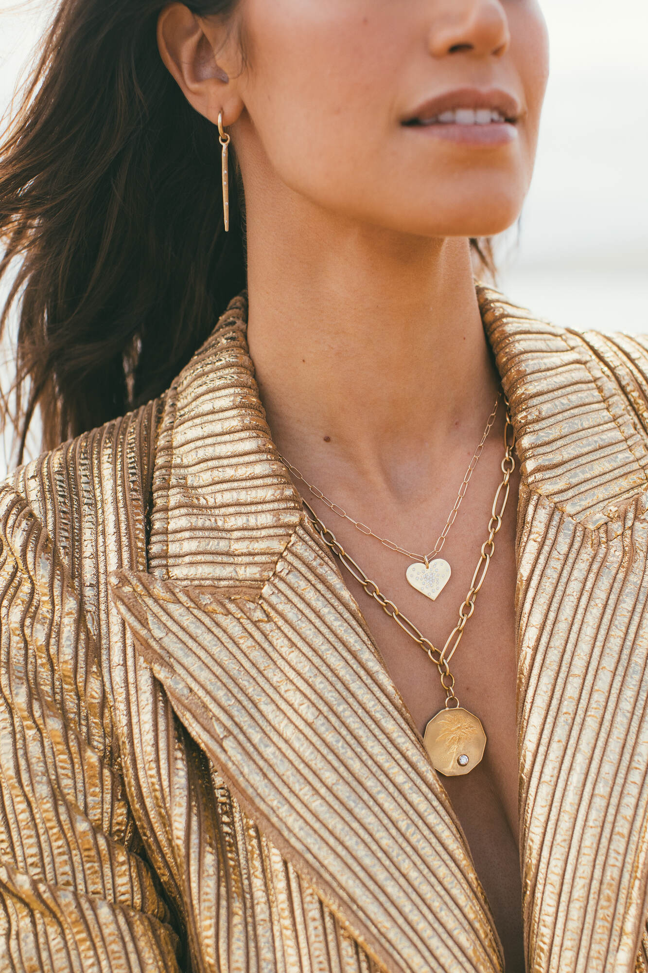 THE GOLD HEART DIAMOND BURST CHARM AROUND THE MODELS NECK