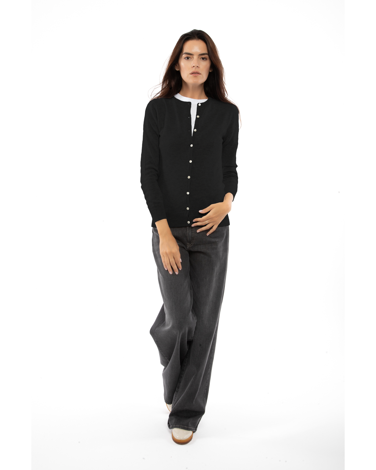 Black cashmere crewneck cardigan, full-length front view styled with dark trousers