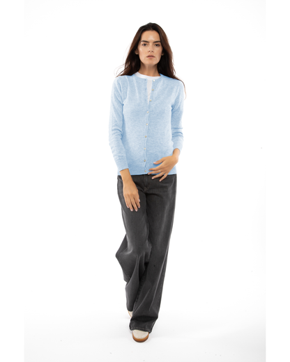 Baby Blue cashmere crewneck cardigan, full-length front view styled with dark trousers