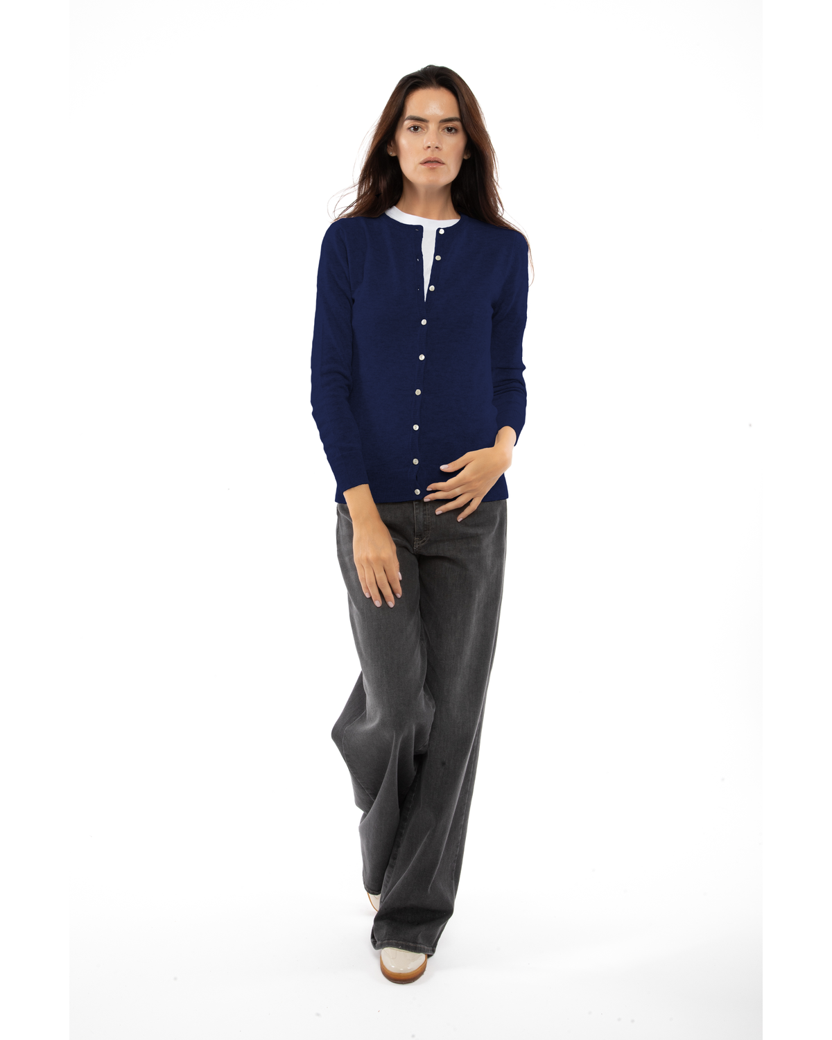 Blue cashmere crewneck cardigan, full-length front view styled with dark trousers