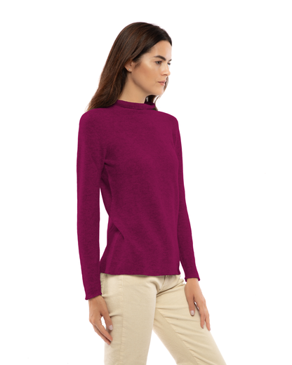 Women's cashmere links stitch funnel neck sweater in Magenta, three-quarter view on a model