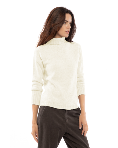 Women's classic cashmere turtleneck sweater in Milk White, three-quarter view on a model