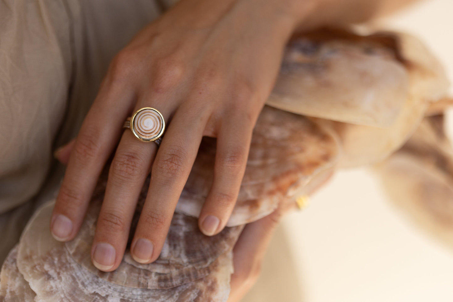 THE PUKA STACKING SWIRL RING-ONE-OF-A-KIND ON A MODELS HAND 