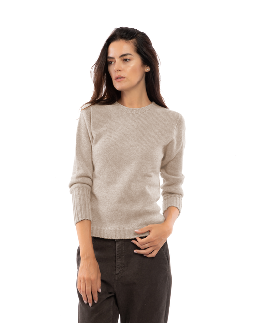 Beige cashmere crewneck sweater with ribbed trim, shown from the front on a model.