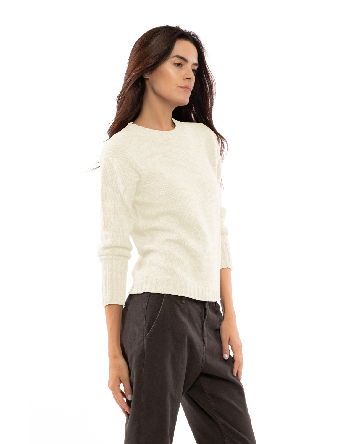 Milk white cashmere crewneck sweater with ribbed trim, shown at an angle on a model.