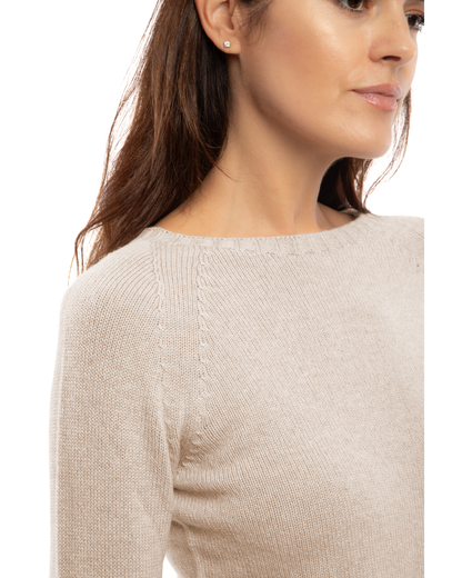 Close-up of the neckline of a cashmere raglan crewneck sweater in beige