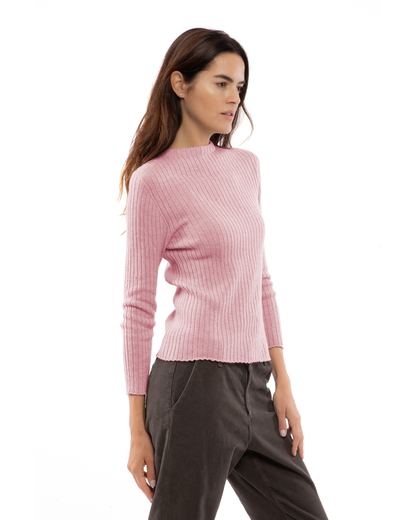Baby pink cashmere ribbed crewneck sweater, shown at an angle on a model.