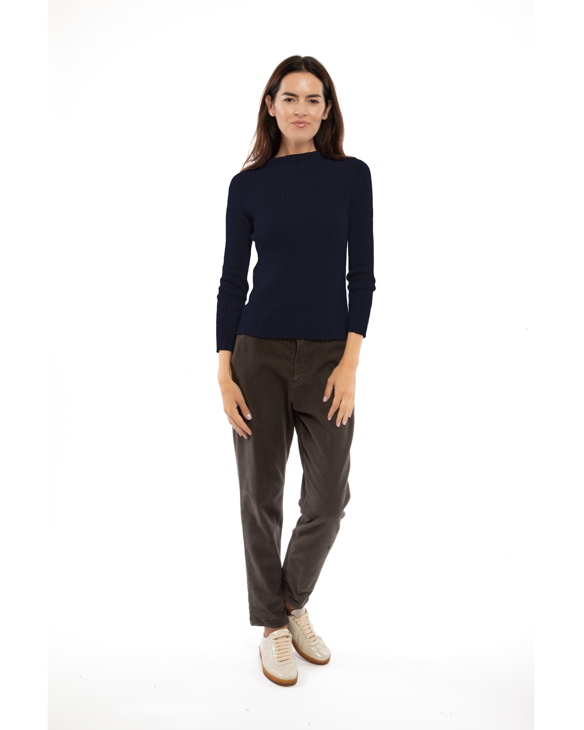 Model wearing a cashmere vertical rib crewneck sweater in night blue, front view