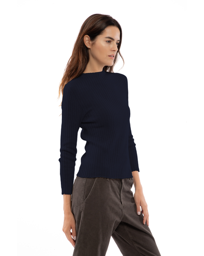 Night blue cashmere ribbed crewneck sweater, shown at an angle on a model.