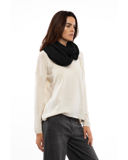 Model wearing a maxi cashmere infinity scarf in black, front view