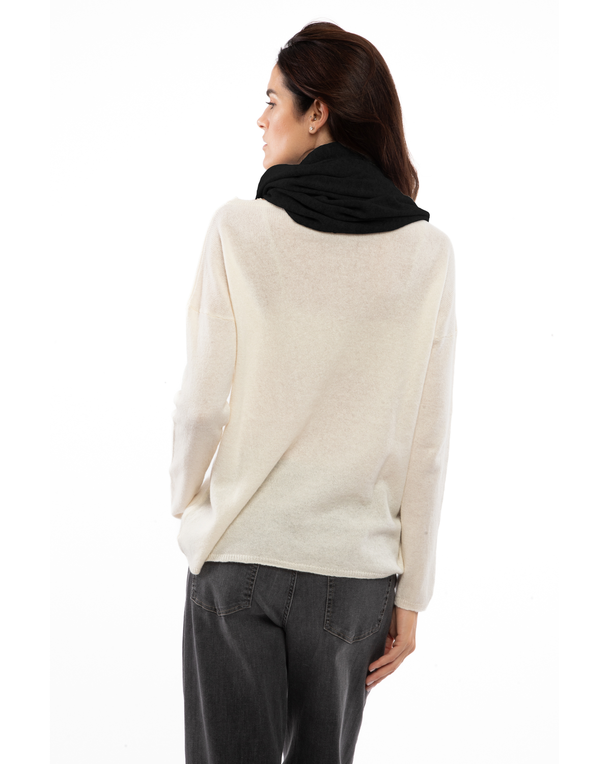 Black cashmere infinity scarf looped around a model’s neck, viewed from behind.