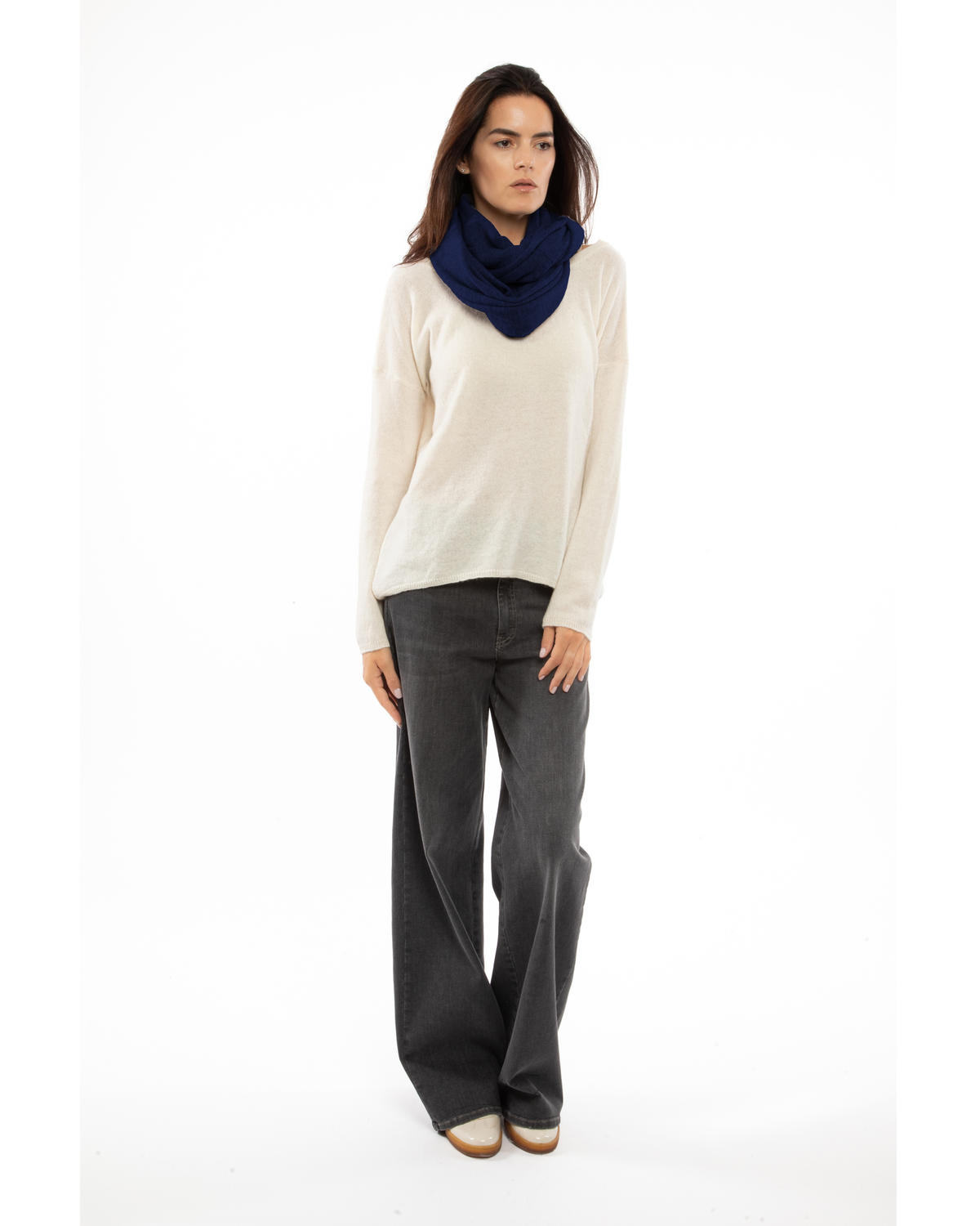 Blue maxi cashmere infinity scarf wrapped around a model’s neck.
