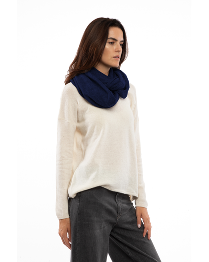 Model wearing a maxi cashmere infinity scarf in blue, front view