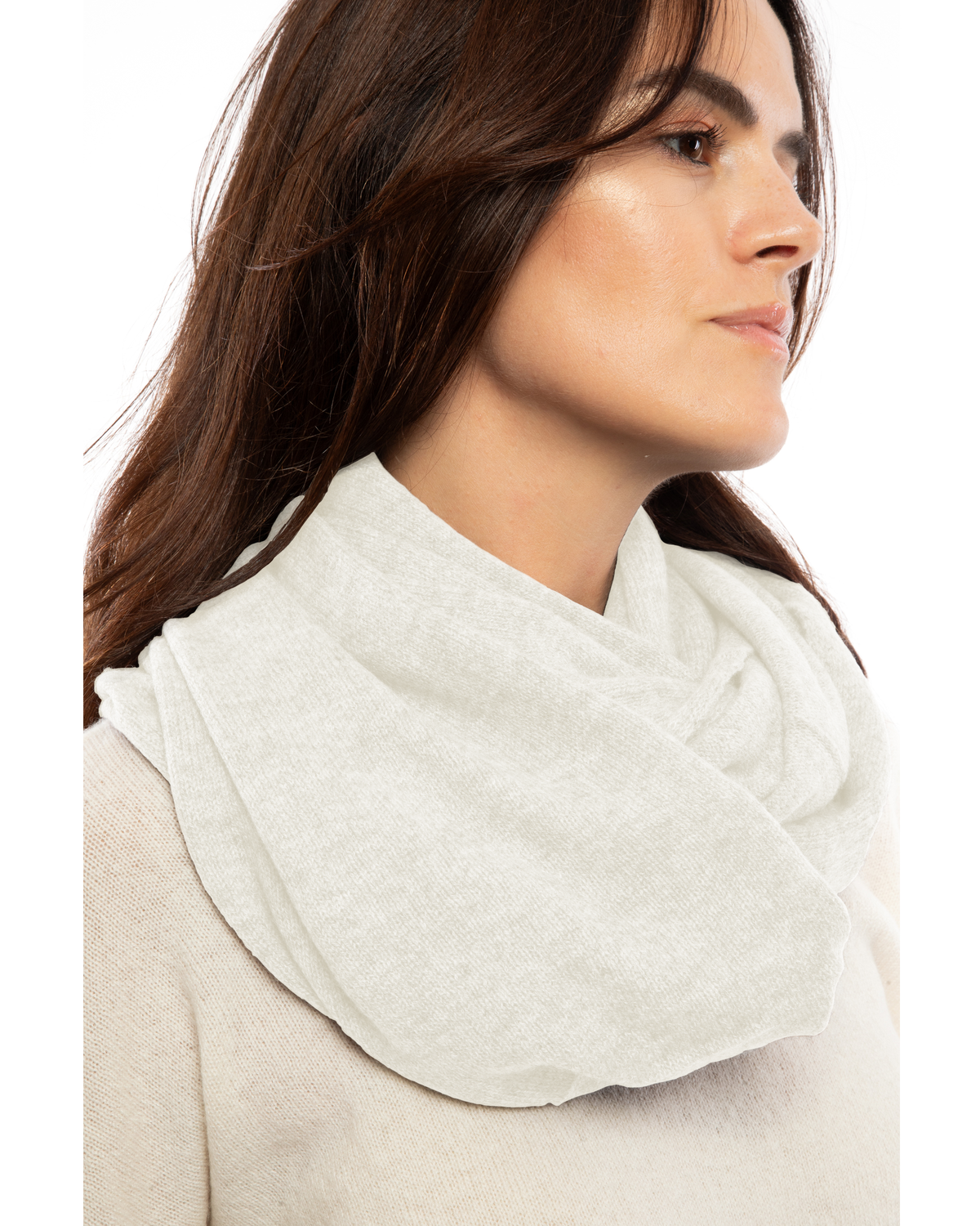 Milk white maxi cashmere infinity scarf wrapped around a model’s neck.