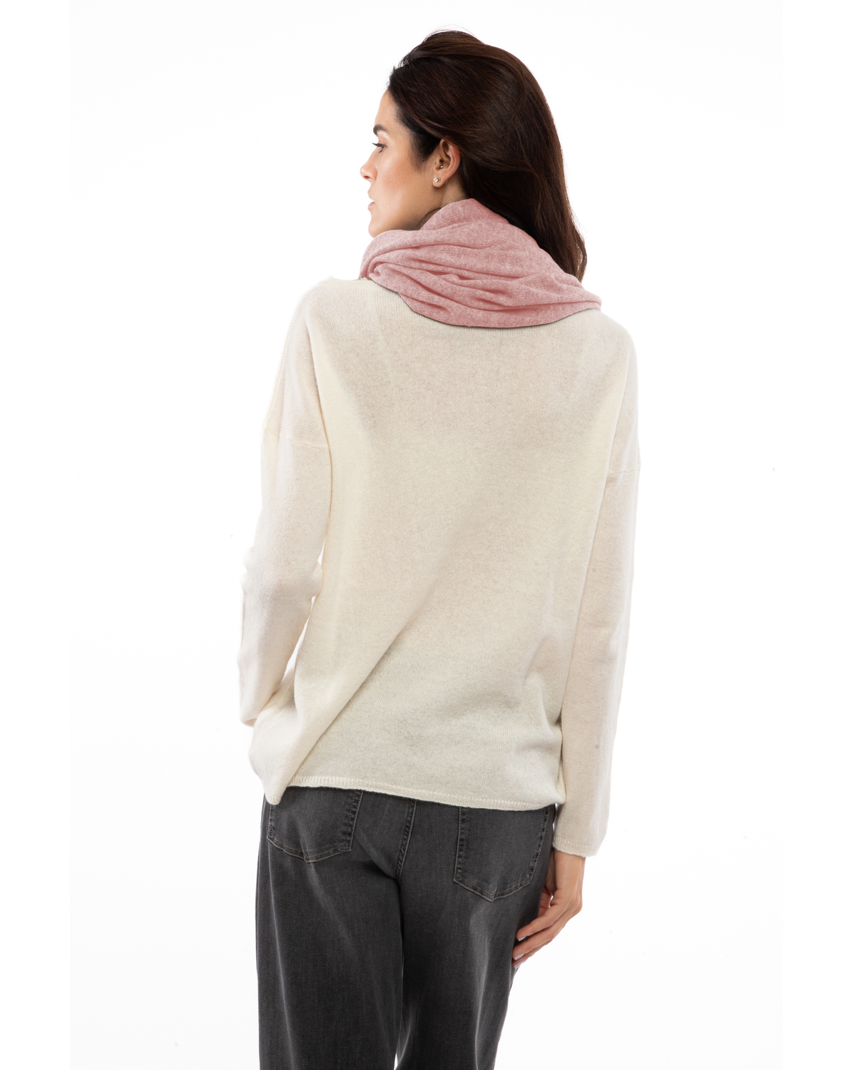 Old rose cashmere infinity scarf looped around a model’s neck, viewed from behind.