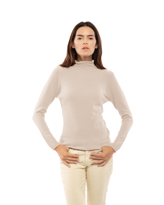 Front view of a model wearing the Beige ultralight cashmere raglan turtleneck, with hands resting near the hips.