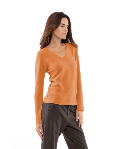 Saffron pure cashmere links-stitch V-neck sweater, three-quarter view on a model.