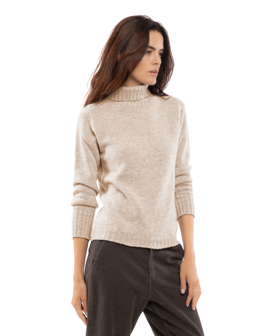 Beige classic cashmere turtleneck sweater, three-quarter view on a model.