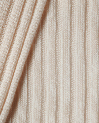 Close-up of beige knitted fabric with visible texture