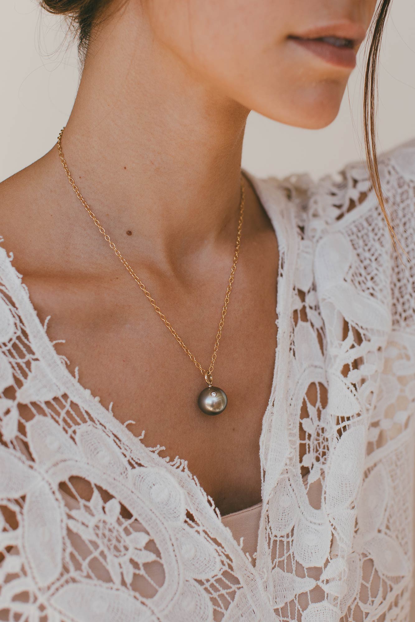 Model wearing charm on neck